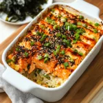 Close-up of baked Miso Salmon Sushi Bake with a serving scooped out