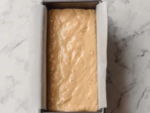 Loaf pan filled with flourless banana bread batter ready to bake