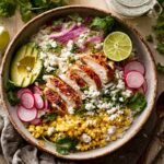 30-Minute Street Corn Chicken Rice Bowl 9 treet corn chicken rice bowl with avocado, radish, and lime on rustic table