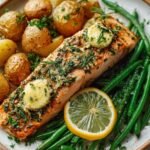 baked salmon with garlic butter, potatoes, and green beans on plate