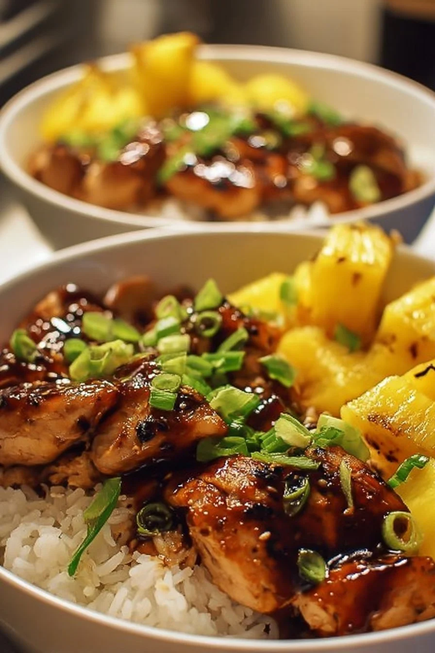 Teriyaki chicken and pineapple bowl garnished with fresh herbs