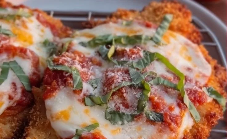 Delicious 30 Minute Chicken Parmesan garnished with herbs on a plate