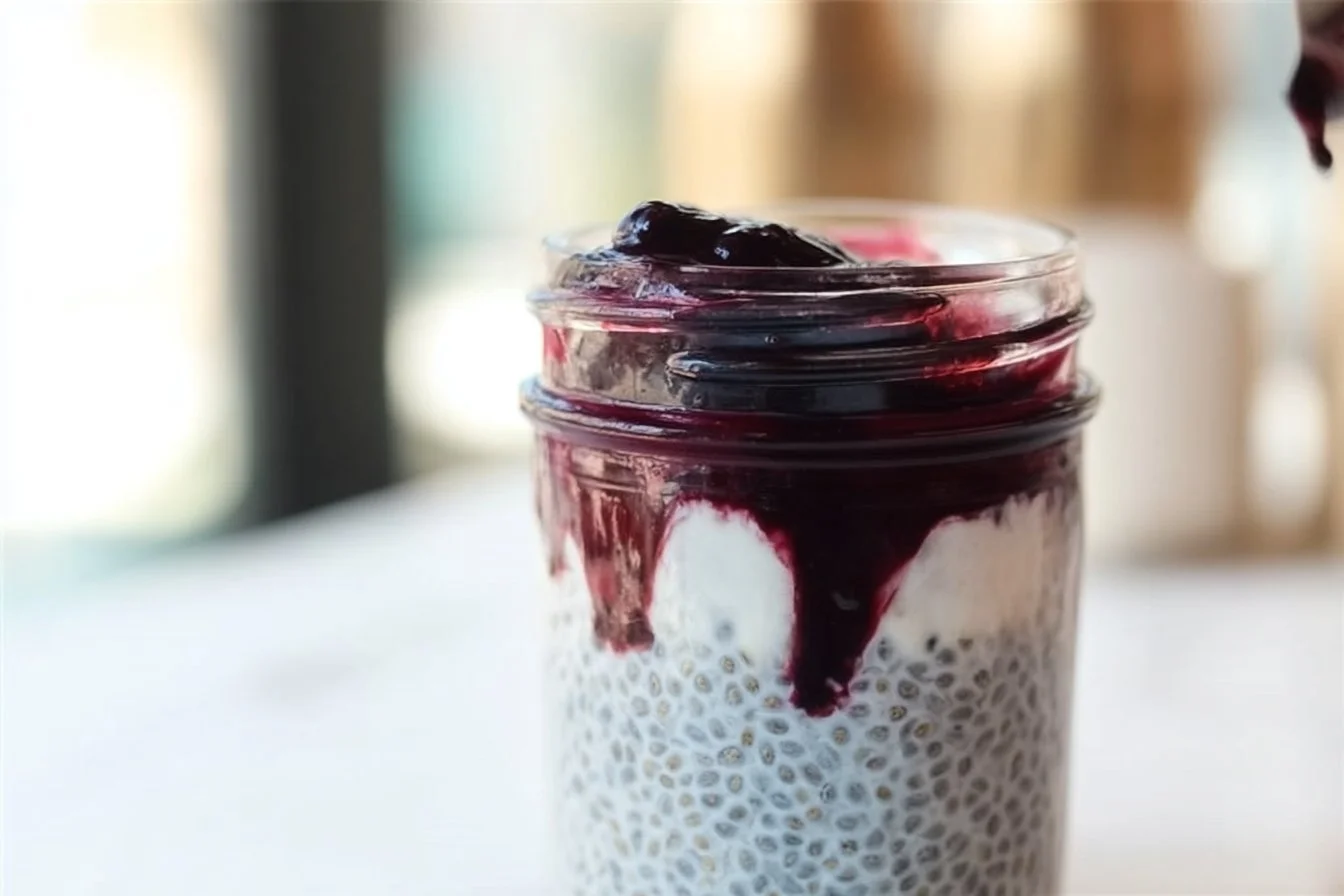 Delicious blueberry coconut chia seed pudding in a bowl with fresh berries on top