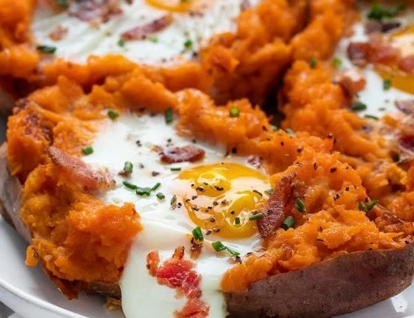Deliciously baked breakfast sweet potato topped with spices and herbs.