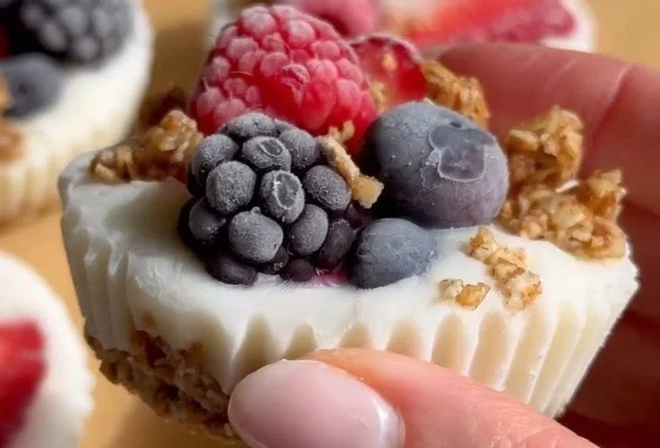 Frozen yogurt cups with granola and mixed berries